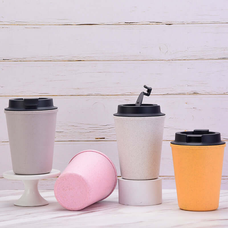 Assorted eco-friendly wheat straw coffee cups, including a yellow 350ml double-layer design, perfect for sustainable and stylish use.